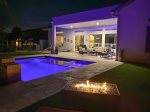 Night view of pool and firepit 